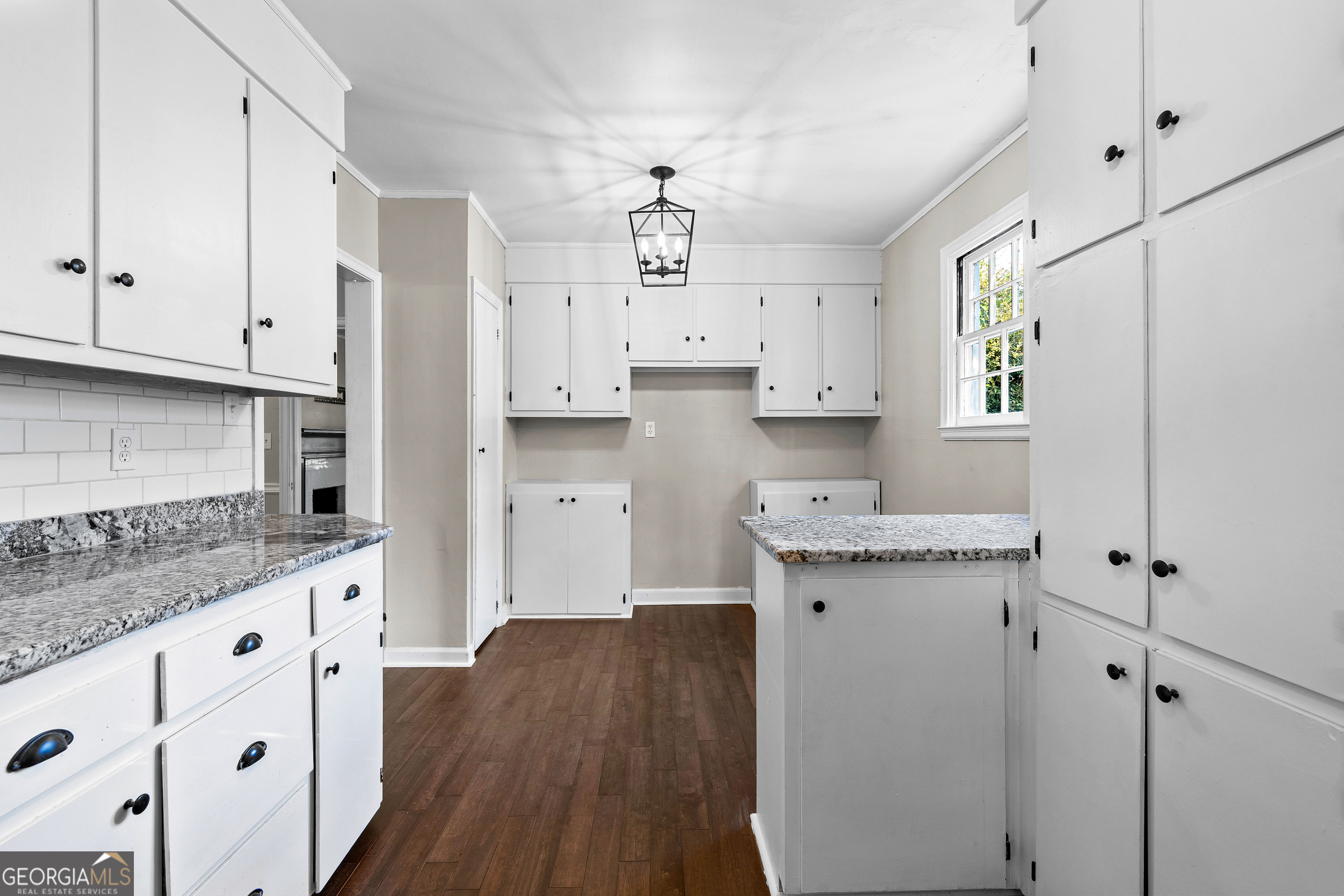 213 N Street Southwest Thomaston, GA 30286 - Photo 20 of 38 a kitchen with granite countertop a sink a stove and cabinets