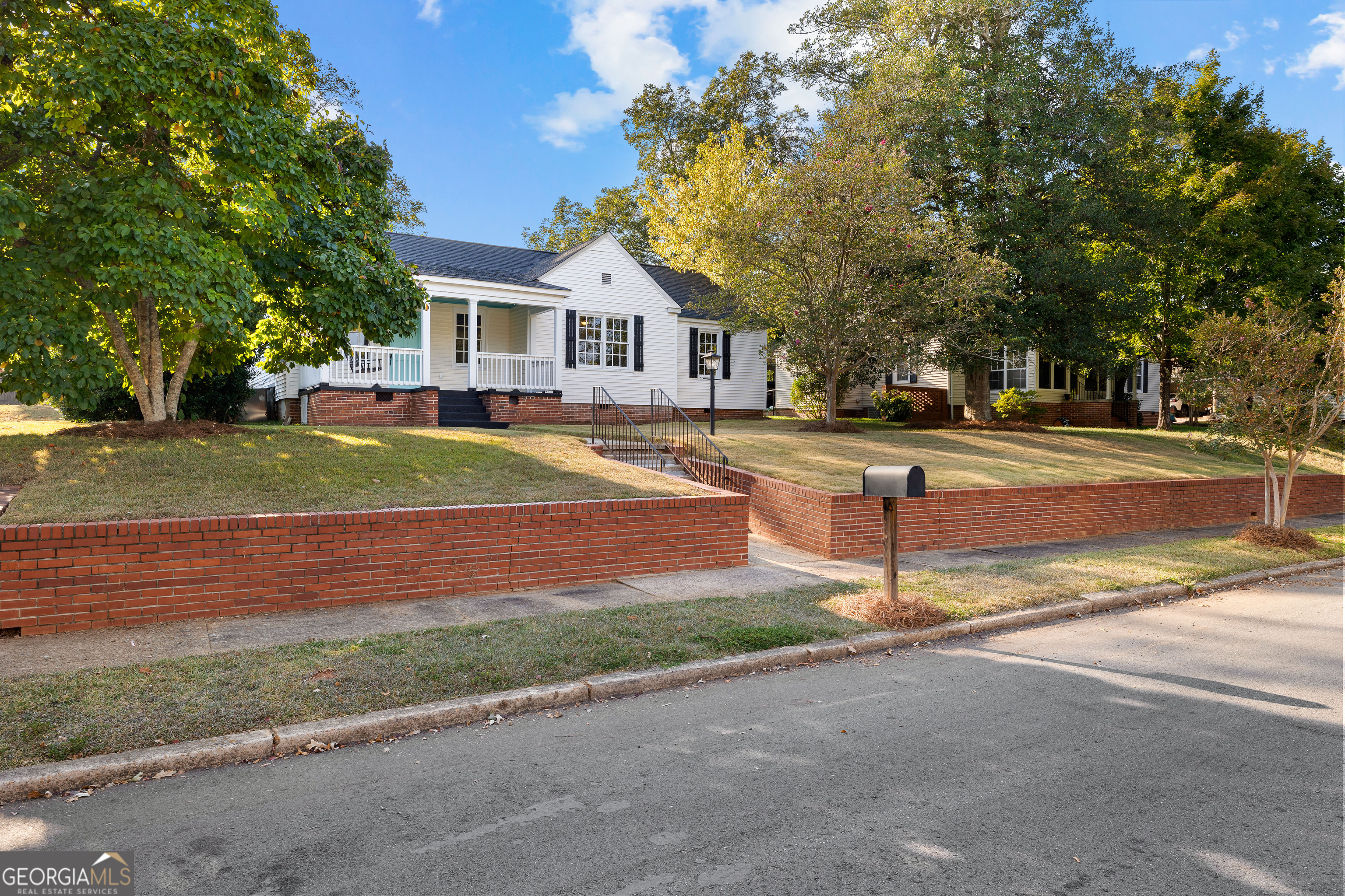 213 N Street Southwest Thomaston, GA 30286 - Photo 2 of 38 a front view of a house with a yard and garage