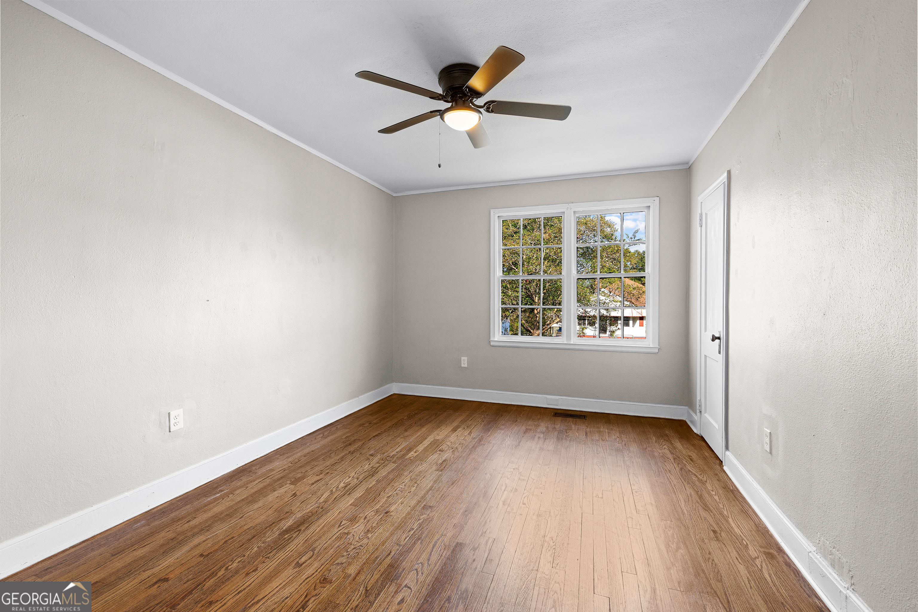213 N Street Southwest Thomaston, GA 30286 - Photo 21 of 38 an empty room with wooden floor windows and fan