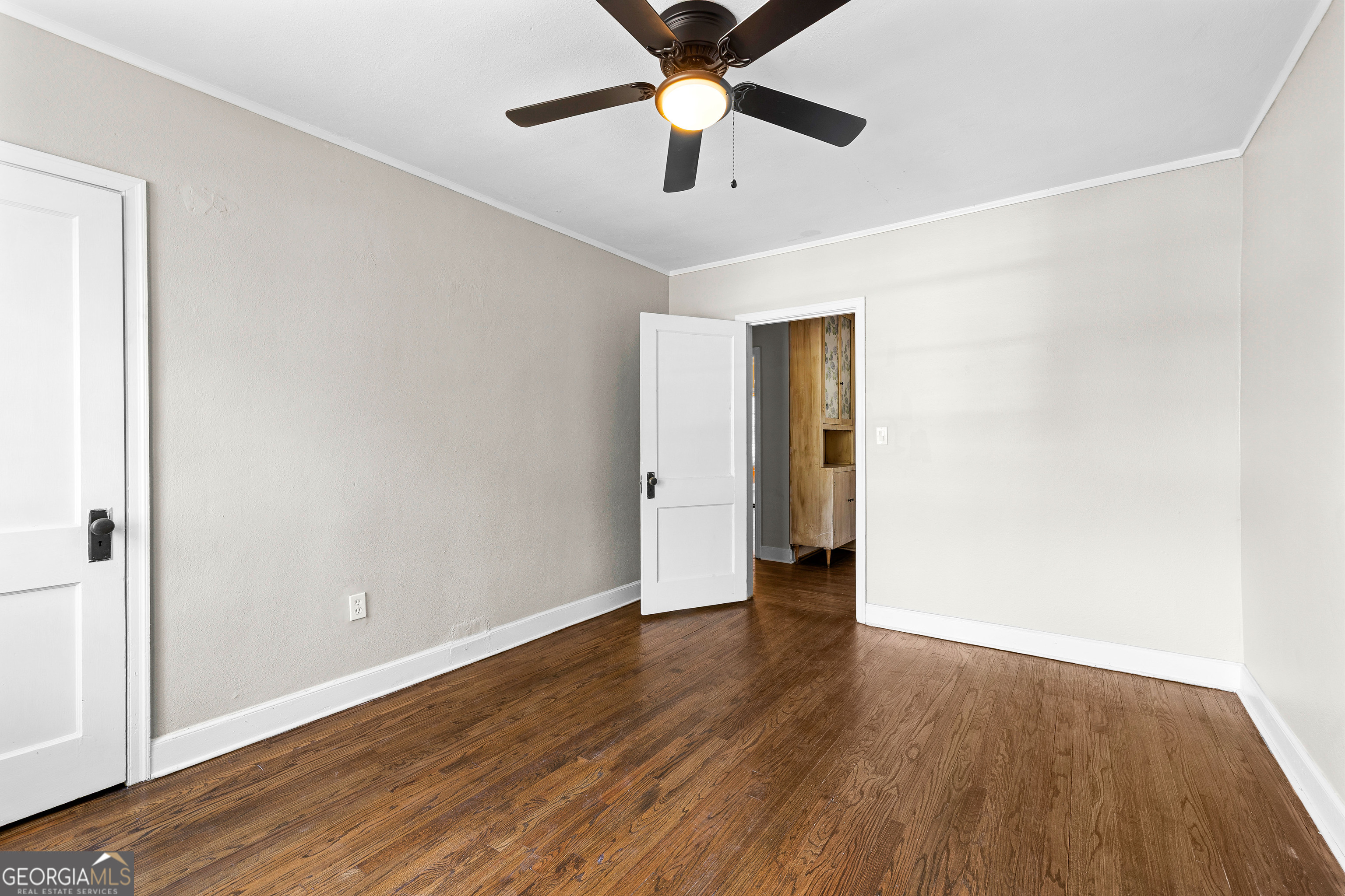 213 N Street Southwest Thomaston, GA 30286 - Photo 22 of 38 an empty room with wooden floor and a ceiling fan