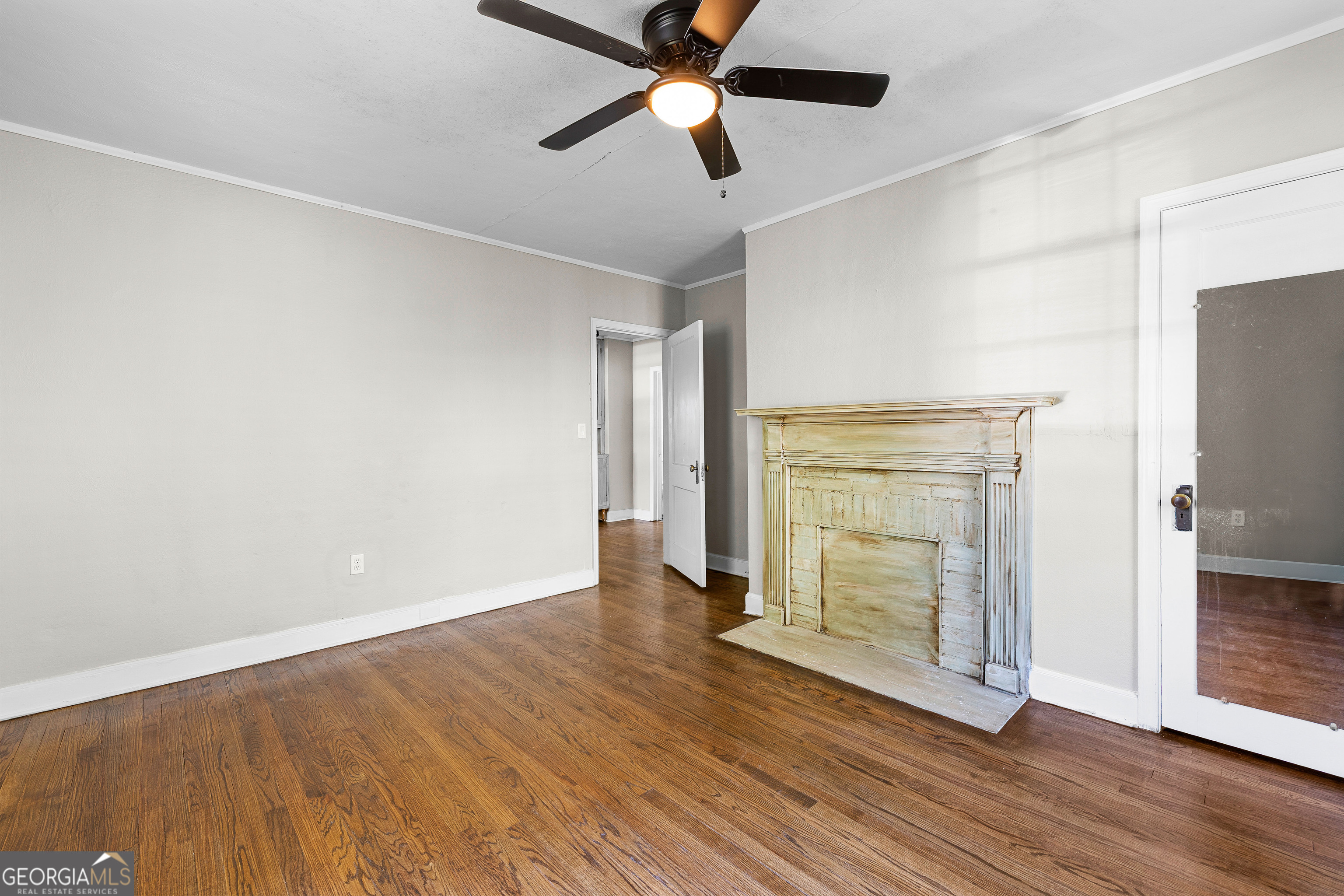 213 N Street Southwest Thomaston, GA 30286 - Photo 25 of 38 wooden floor in an empty room with a fireplace