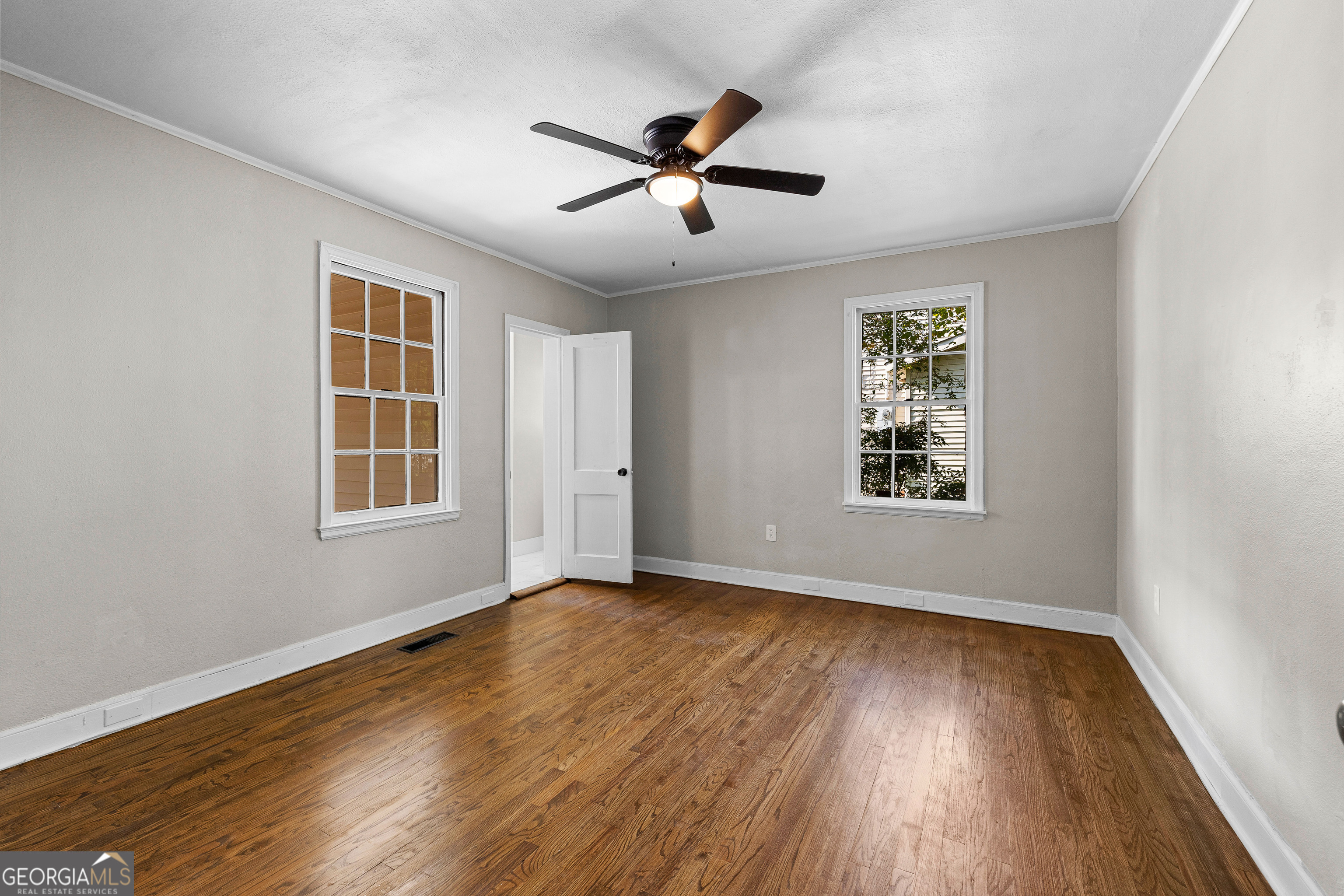 213 N Street Southwest Thomaston, GA 30286 - Photo 28 of 38 a view of an empty room with wooden floor and a window