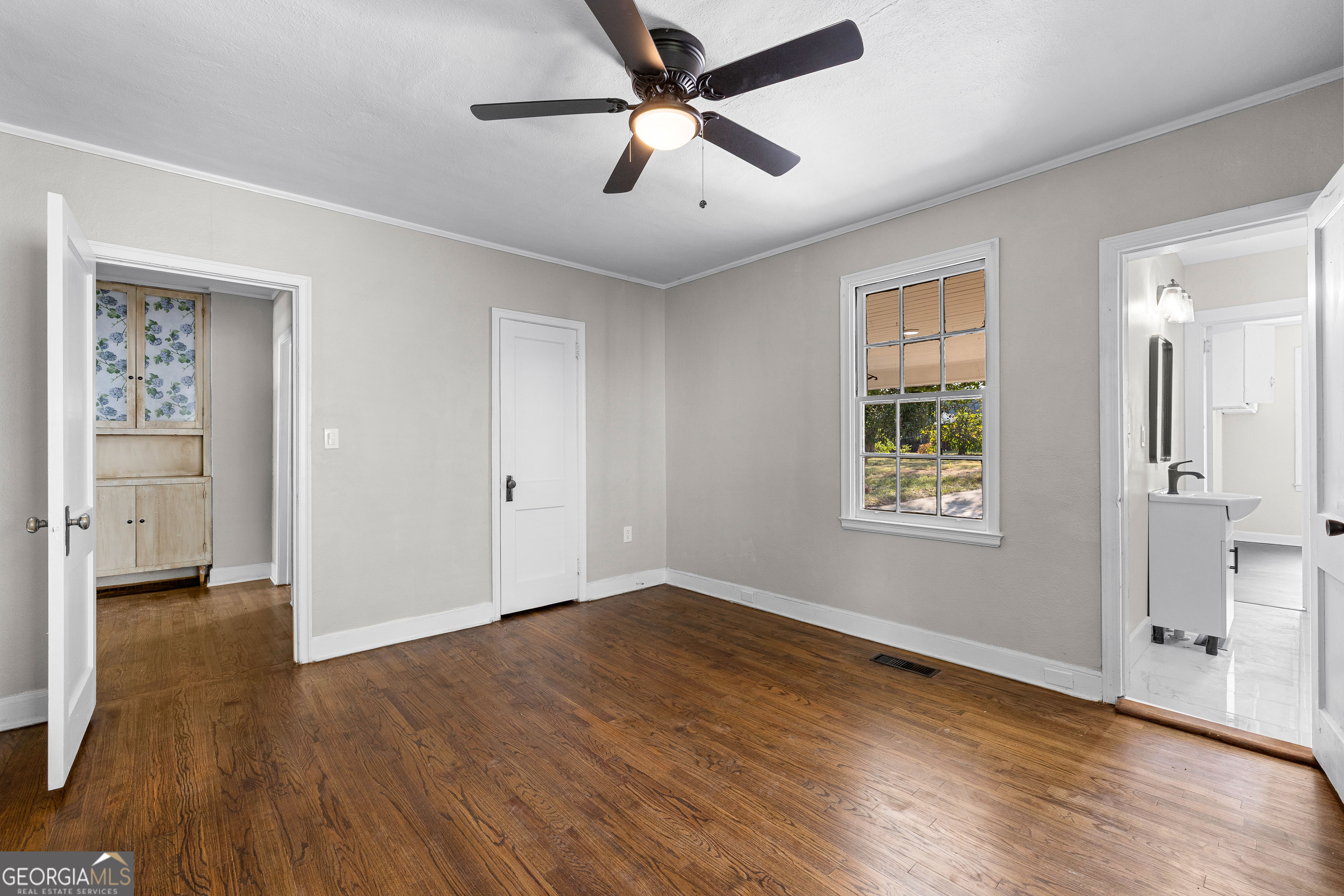 213 N Street Southwest Thomaston, GA 30286 - Photo 30 of 38 a view of empty room with wooden floor and fan