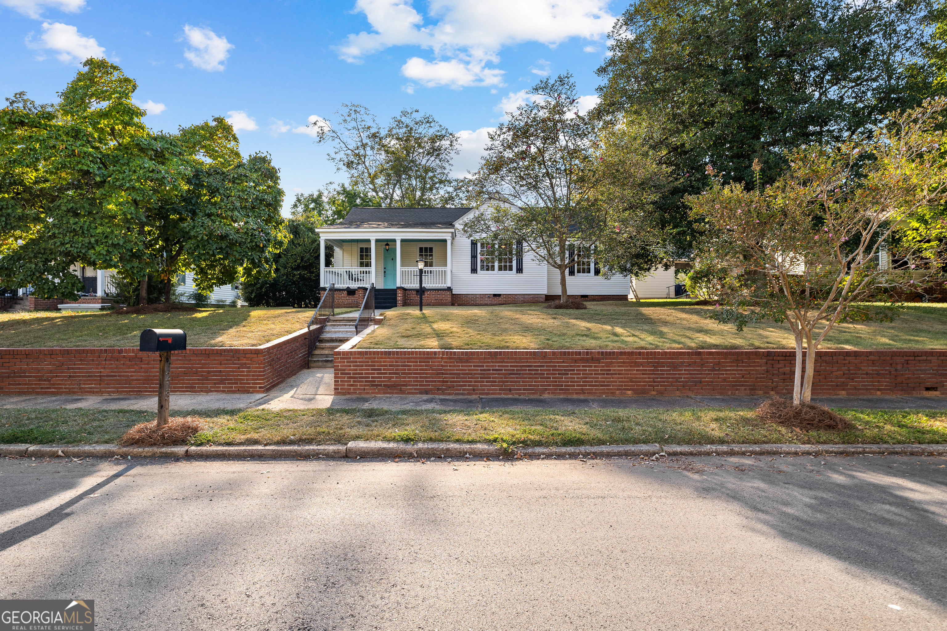 213 N Street Southwest Thomaston, GA 30286 - Photo 3 of 38 a front view of a house with a yard and trees