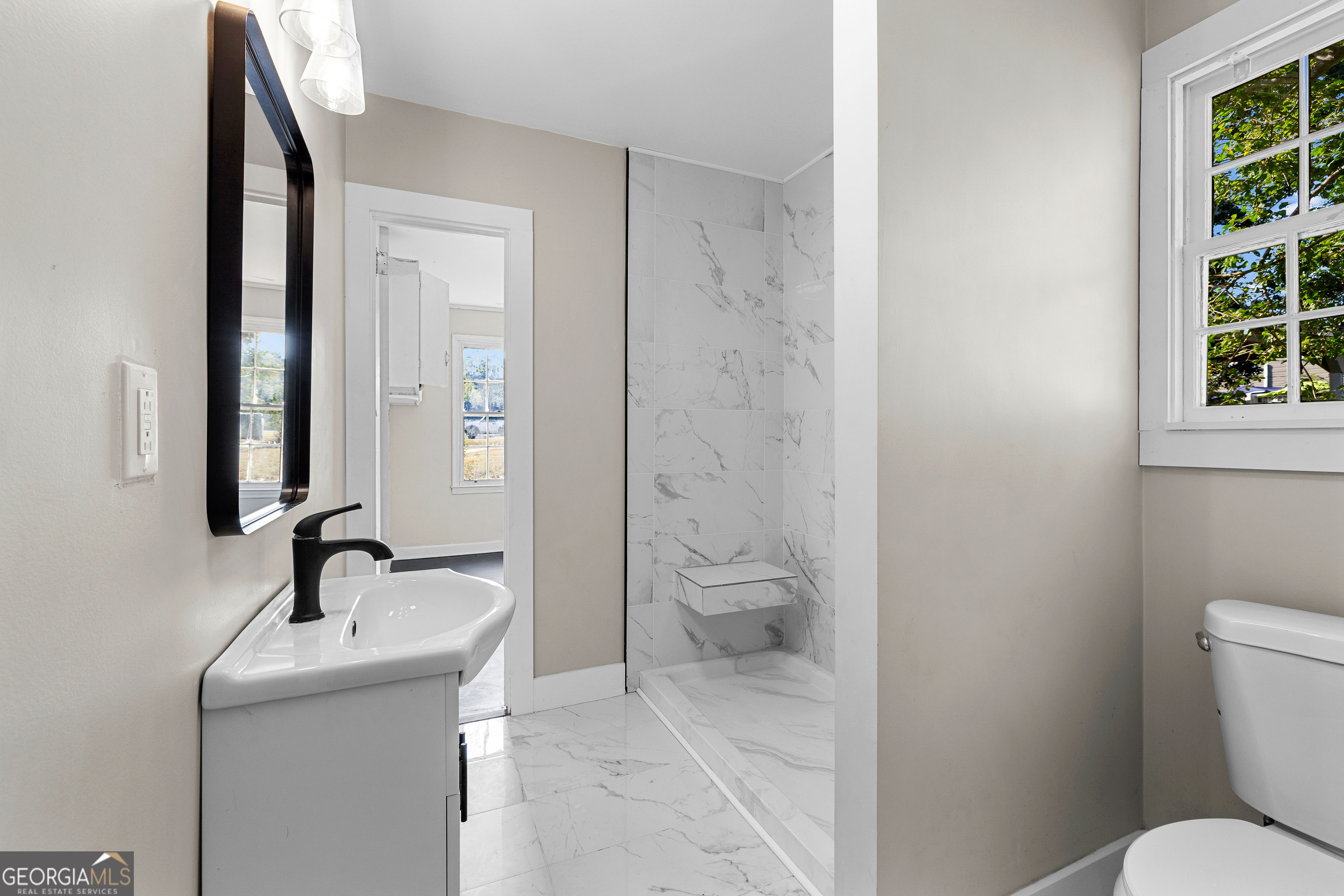 213 N Street Southwest Thomaston, GA 30286 - Photo 31 of 38 a bathroom with a sink a toilet and a mirror