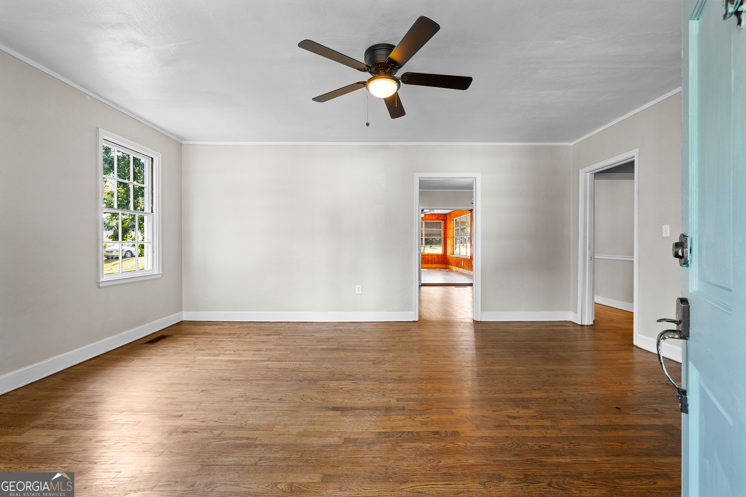 213 N Street Southwest Thomaston, GA 30286 - Photo 7 of 38 a view of an empty room with window and wooden floor