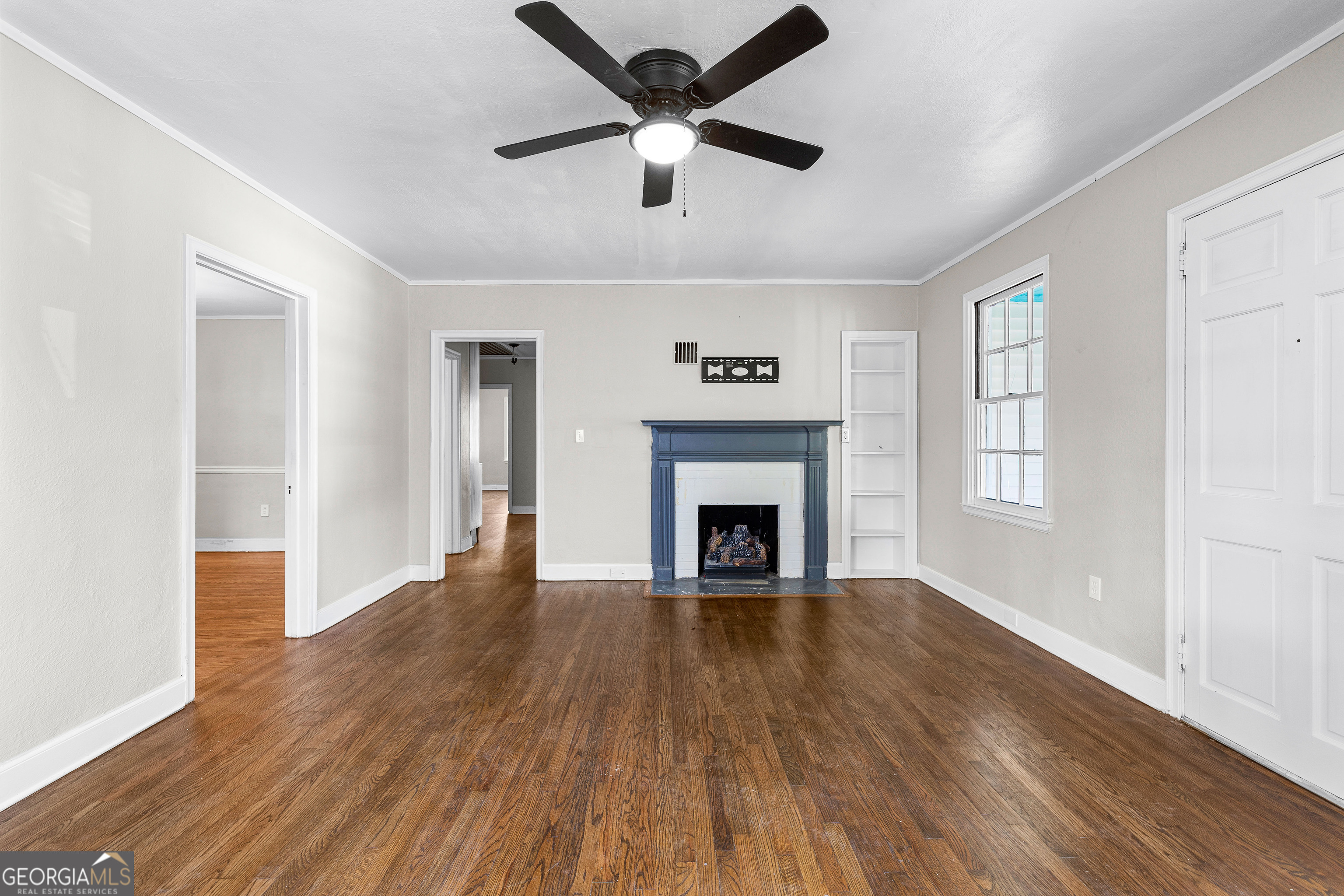 213 N Street Southwest Thomaston, GA 30286 - Photo 8 of 38 a view of an empty room with wooden floor and a window