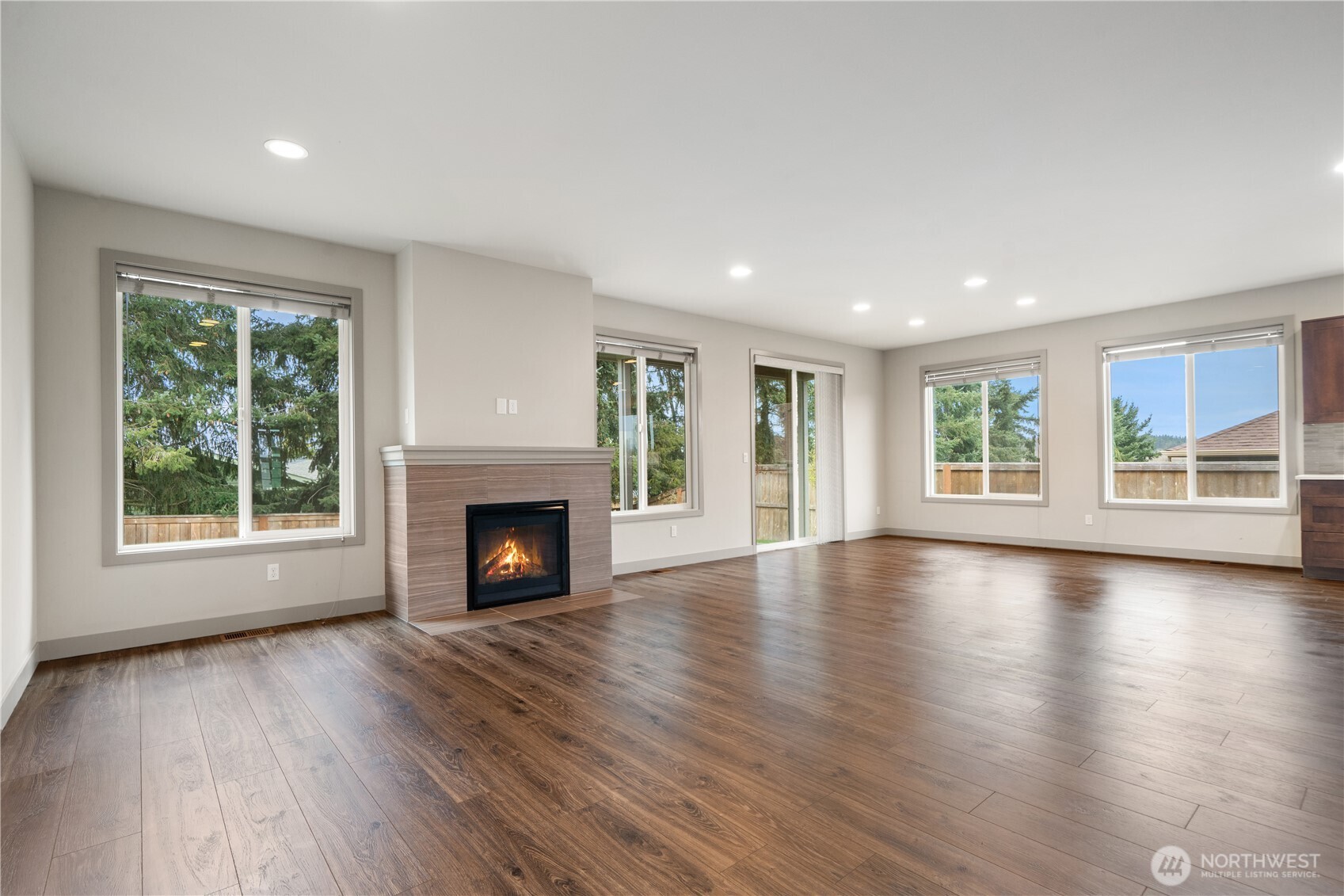 200 Blue Glacier Loop Sequim, WA 98382 - Photo 13 of 39 a view of a livingroom with fireplace wooden floor and windows