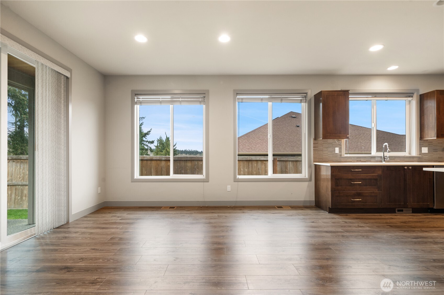 200 Blue Glacier Loop Sequim, WA 98382 - Photo 15 of 39 a view of an empty room with a window and wooden floor