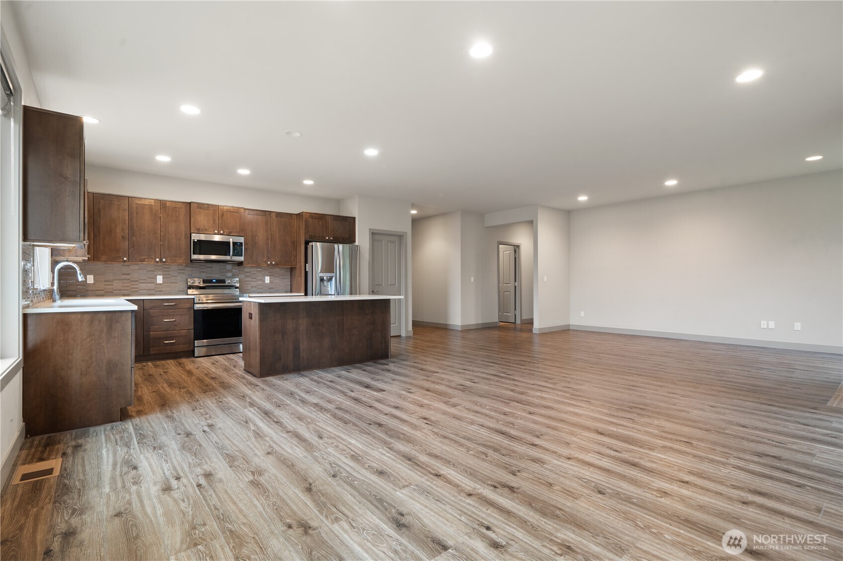 200 Blue Glacier Loop Sequim, WA 98382 - Photo 16 of 39 a large kitchen with stainless steel appliances granite countertop a large counter top a sink and a stove