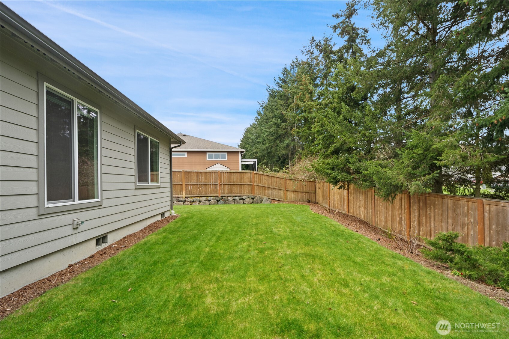 200 Blue Glacier Loop Sequim, WA 98382 - Photo 32 of 39 a view of a backyard with a garden