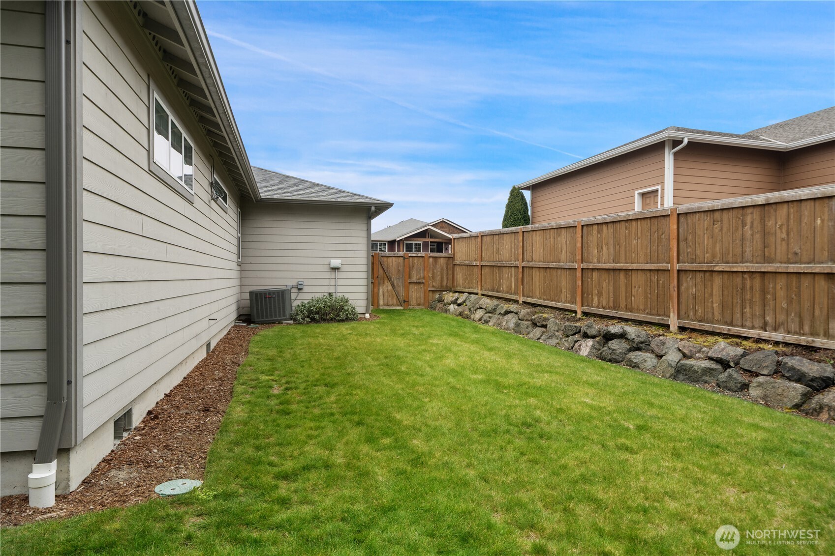 200 Blue Glacier Loop Sequim, WA 98382 - Photo 33 of 39 a view of a backyard with wooden fence