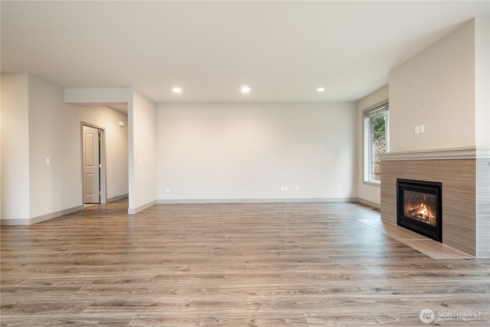 200 Blue Glacier Loop Sequim, WA 98382 - Photo 10 of 39 a view of a livingroom with wooden floor and a fireplace