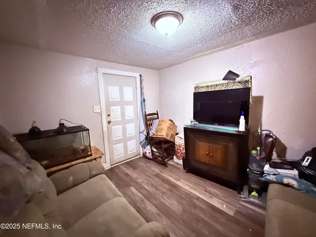 a bedroom with furniture and a flat screen tv