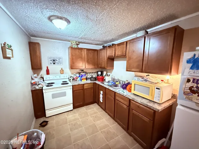a kitchen with stainless steel appliances kitchen island granite countertop a sink stove and cabinets