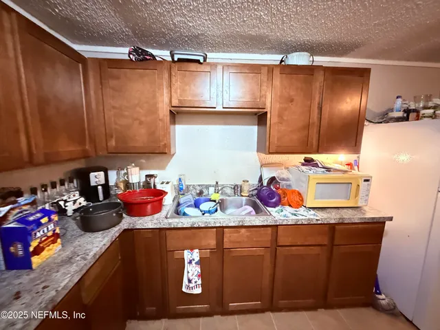 a kitchen with stainless steel appliances granite countertop a sink dishwasher stove and cabinets