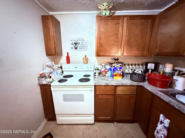 a kitchen with a sink cabinets and window