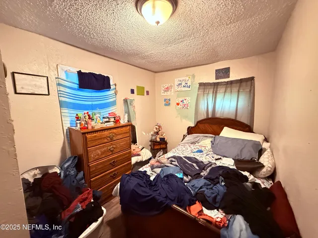 a bedroom with two bed and a closet
