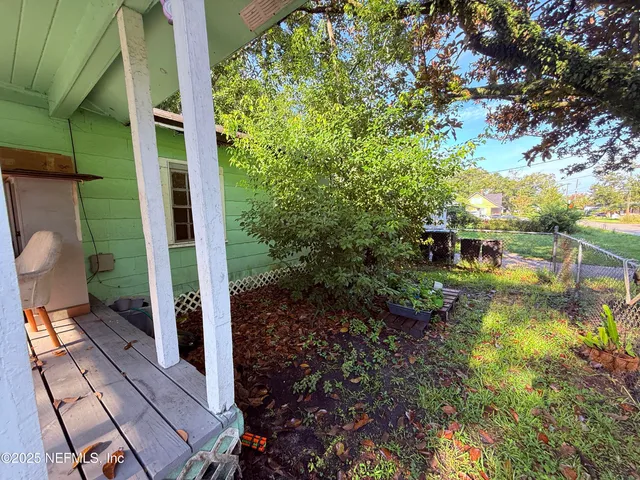 a view of a garden with large trees