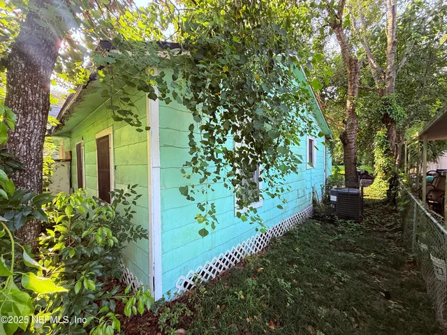 a view of backyard with outdoor seating and green space