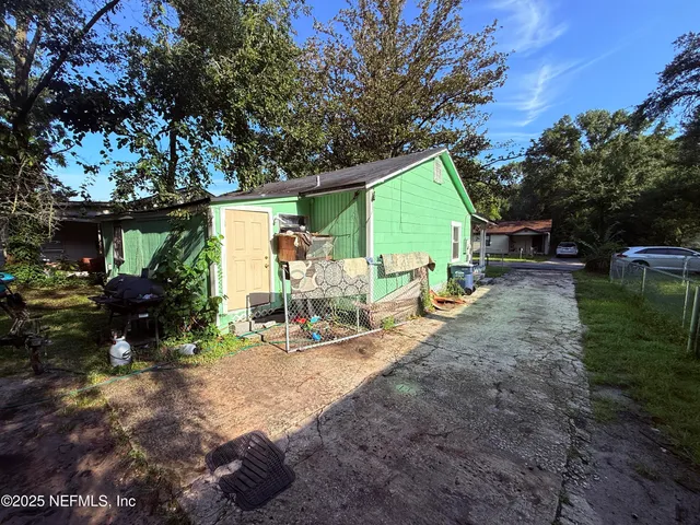 a view of backyard with outdoor seating and green space