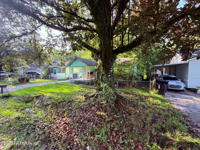 a view of house with backyard space and garden