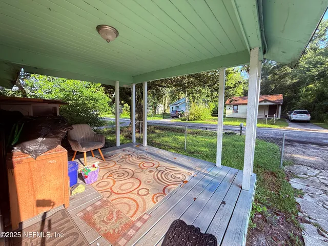 a view of a patio with table and chairs potted plants with wooden floor