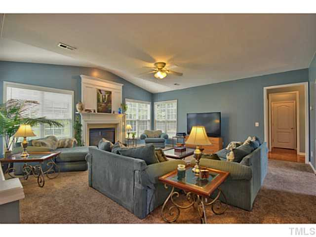 7620 Derek Drive Raleigh, NC 27613 - Photo 6 of 25 The family room is HUGE! It has carpet, ceiling fan and a gas fireplace with mantle. Den/Family/Great Room