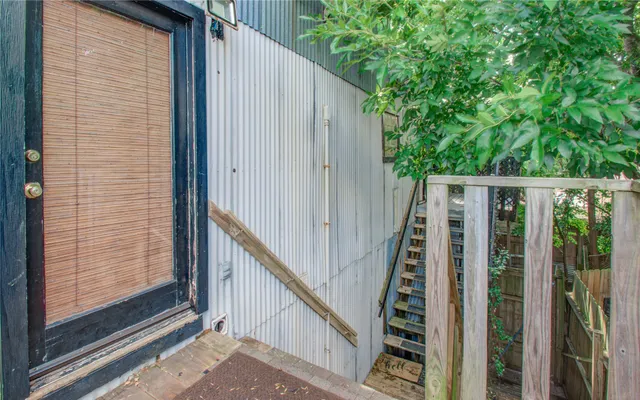 a view of a balcony with wooden floor and fence