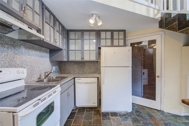 a kitchen with a refrigerator and a sink