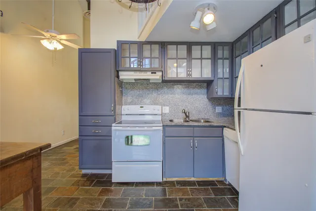 a kitchen with a refrigerator and a stove