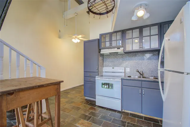 a kitchen with cabinets and window