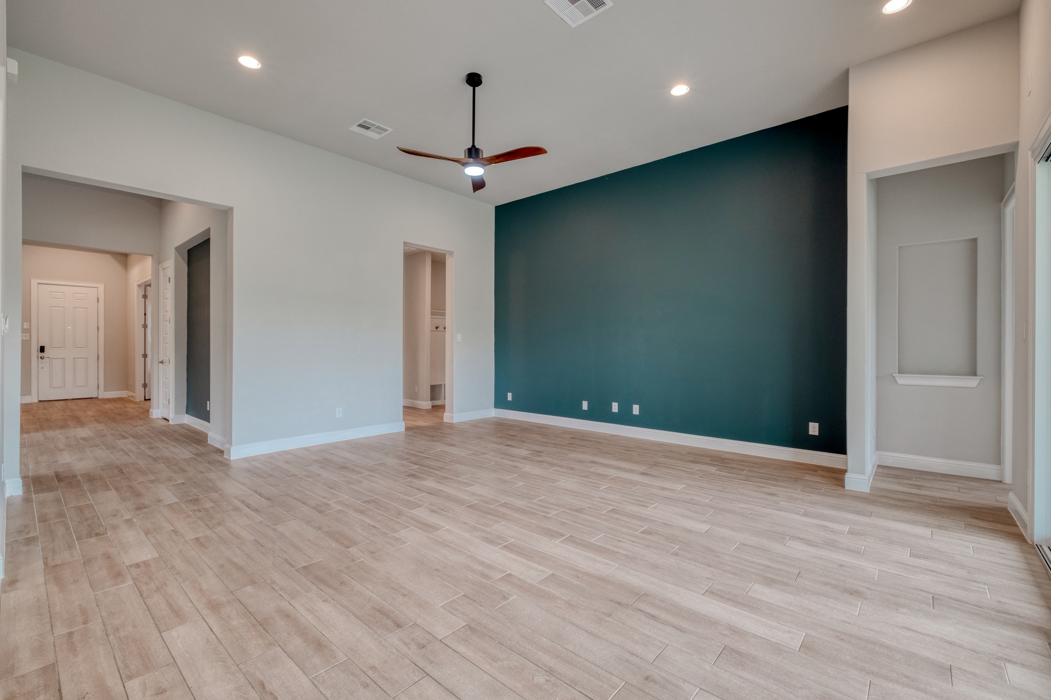359 Raptor Beak Way Cedar Creek, TX 78612 - Photo 5 of 29 With high ceilings and wood-look tile flooring, the living room feels incredibly spacious and stands up beautifully to daily life