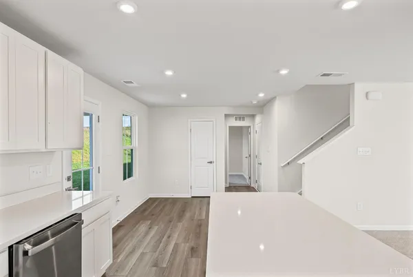 a view of kitchen with wooden floor and electronic appliances