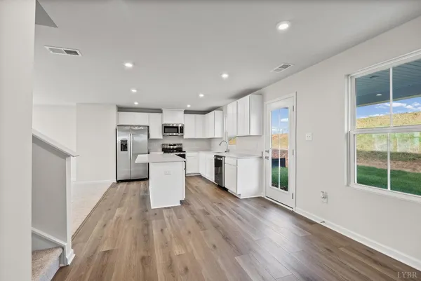 a view of an entryway with wooden floor