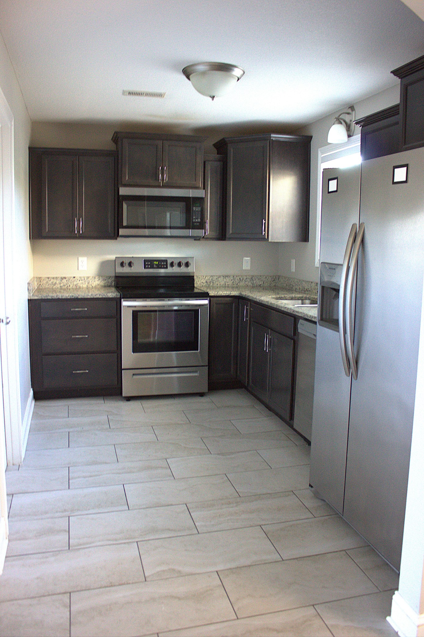 119 Ambridge Street Oak Grove, KY 42262 - Photo 5 of 19 a large kitchen with granite countertop a stove a sink and a refrigerator