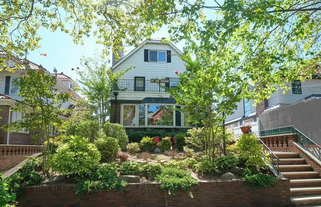 front view of a house with a tree