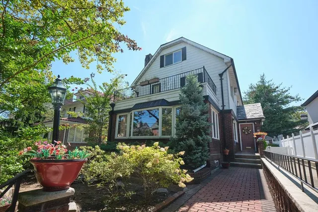 a front view of a house with garden