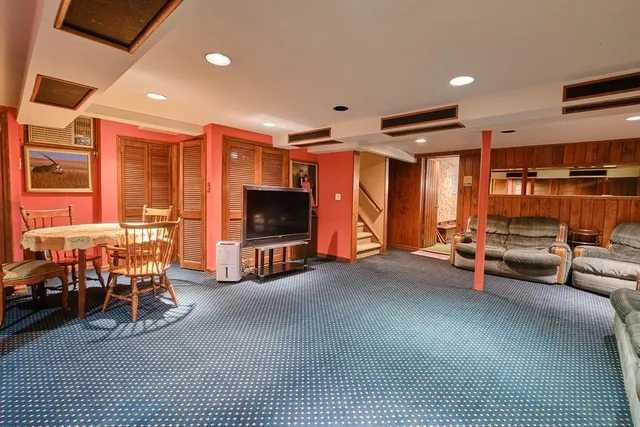 a room with pool table and wooden floor