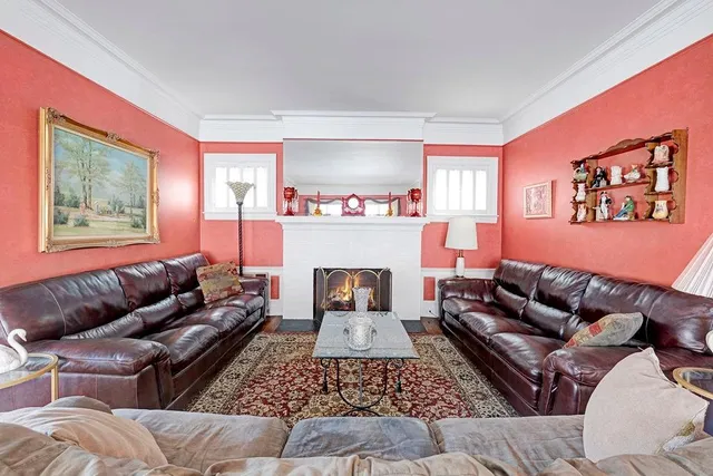 a living room with furniture wooden floor and next to a window