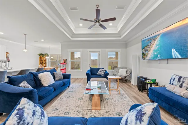 a living room with furniture and a chandelier