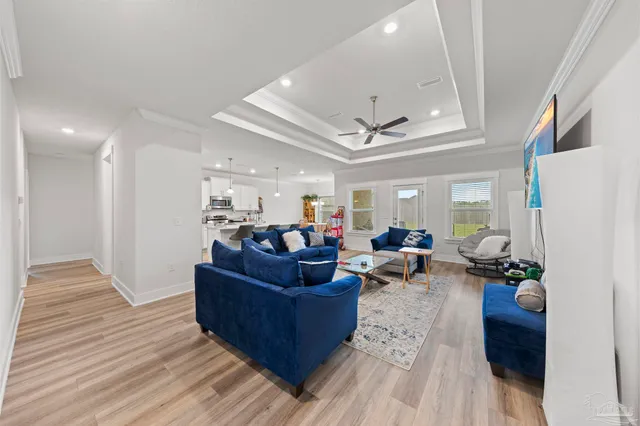 a living room with furniture and wooden floor
