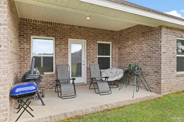 a view of a house with a yard and sitting area