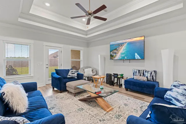 a living room with furniture a rug and a window