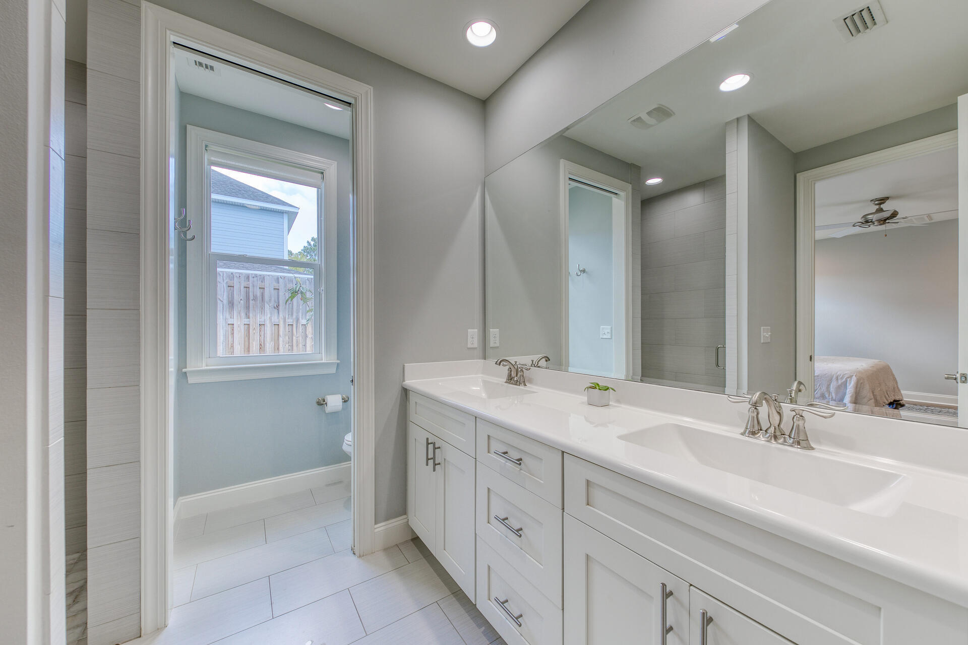 103 Chapman Street Santa Rosa Beach, FL 32459 - Photo 13 of 29 a spacious bathroom with a double vanity sink a mirror and a shower