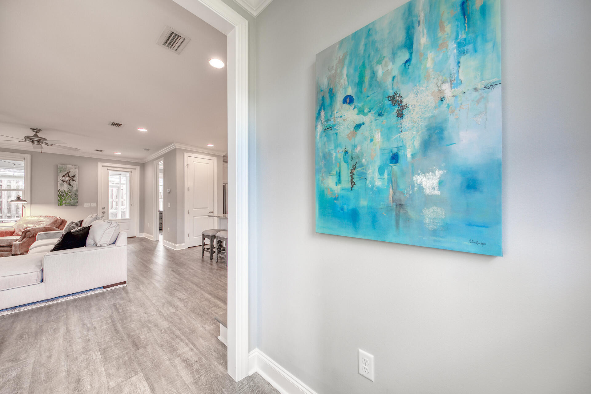 103 Chapman Street Santa Rosa Beach, FL 32459 - Photo 3 of 29 a view of a hallway with wooden floor and furniture