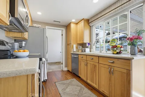 a kitchen with a sink stove and refrigerator