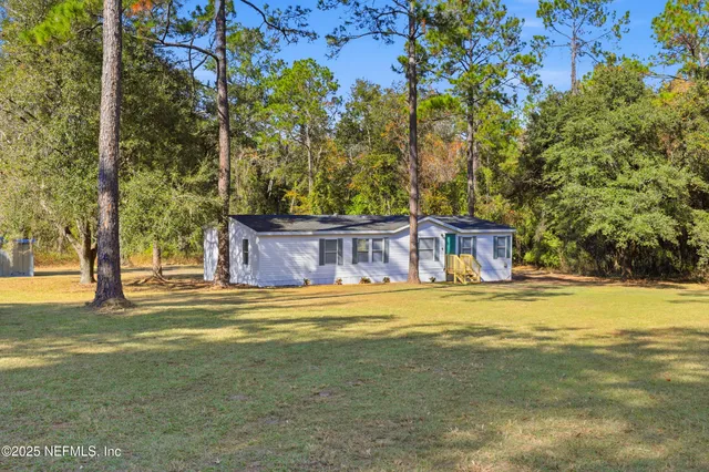 a front view of a house with a yard and swimming pool