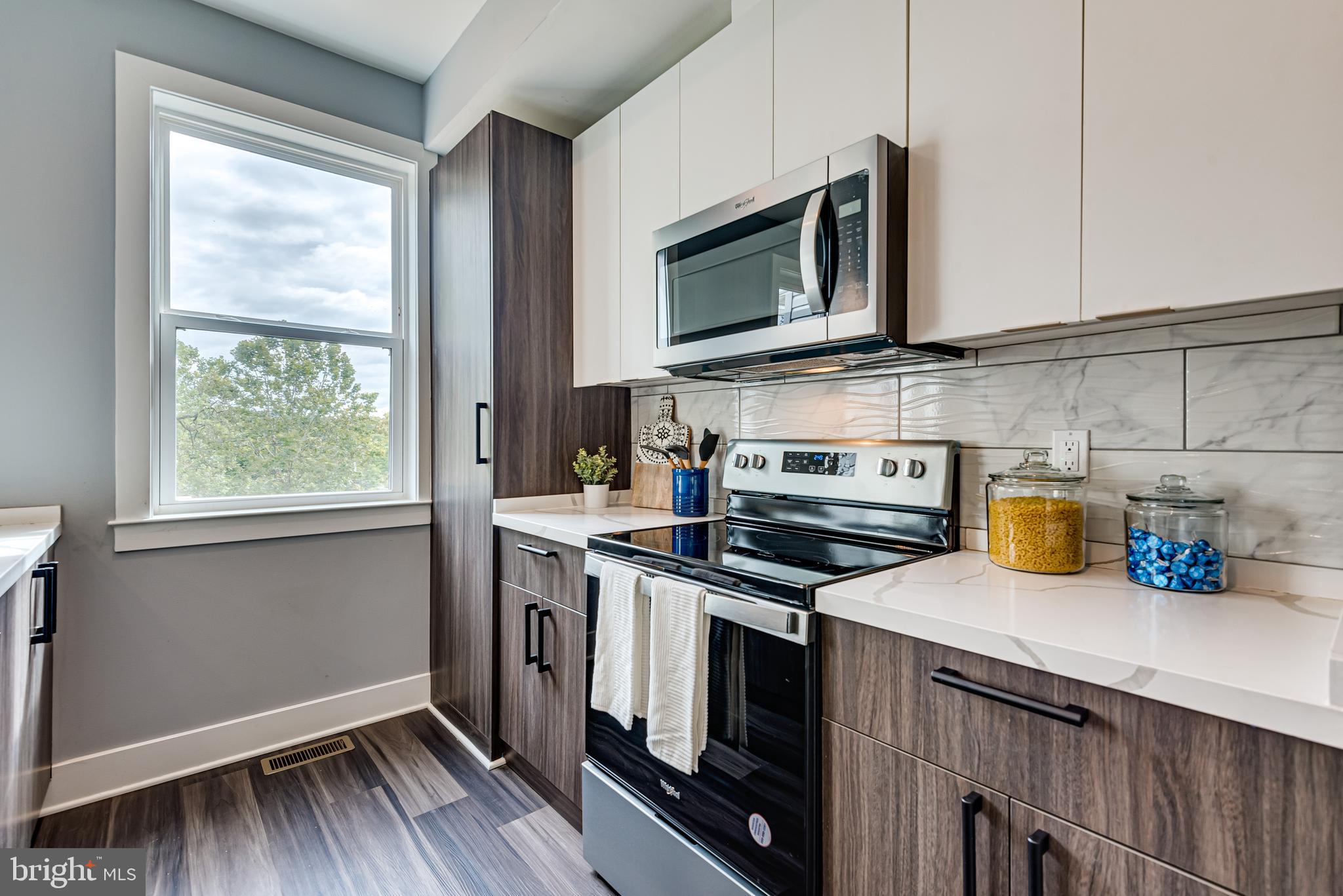 3830 First Street Southeast Washington, DC 20032 - Photo 13 of 49 a kitchen with stainless steel appliances a stove microwave and sink