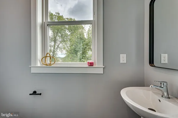 a bathroom with a sink and a window